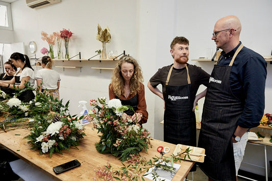 Fig & Bloom florists at work on arrangements at the studio bench