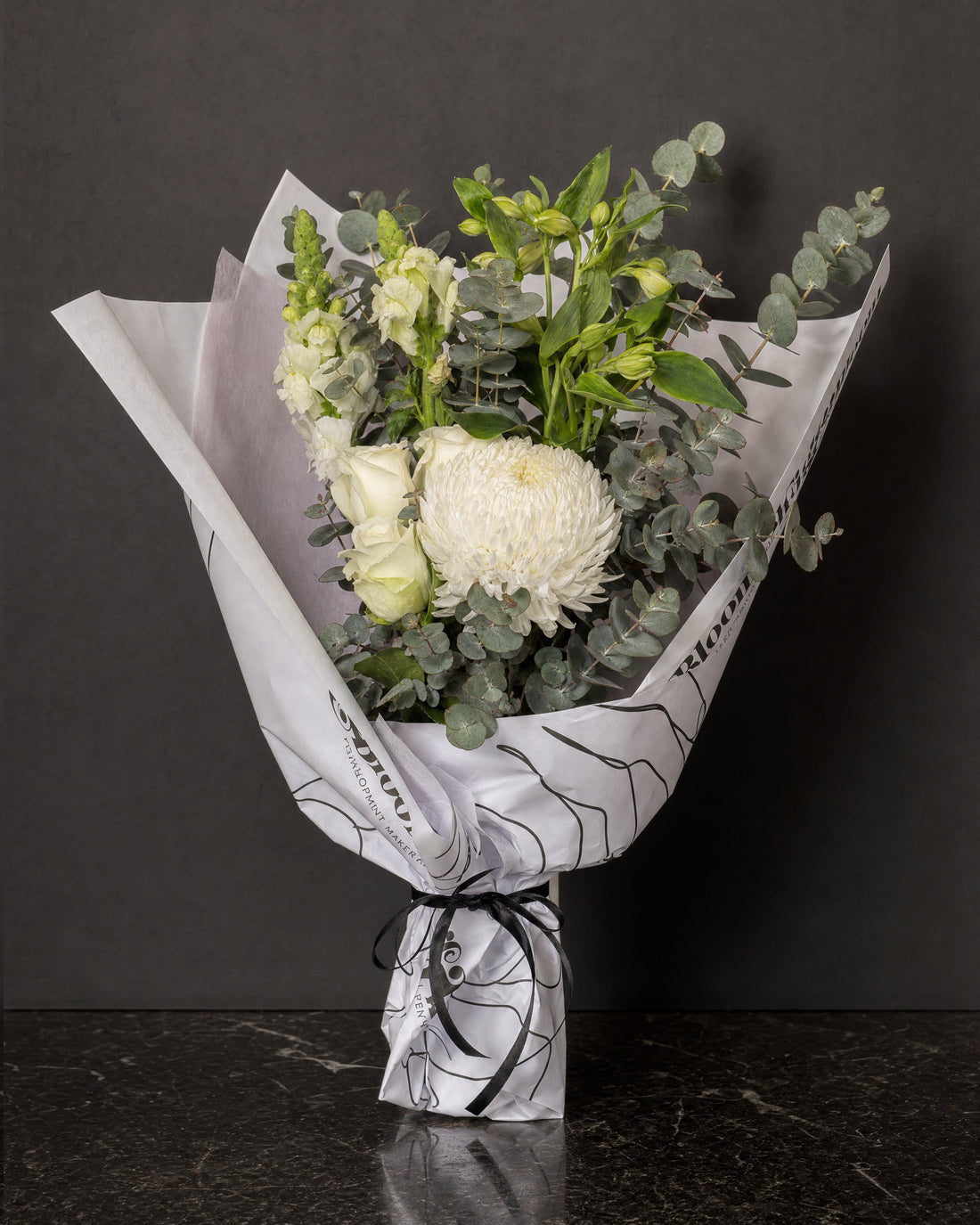 Ravello Posy by Fig & Bloom: white roses, disbud and eucalyptus, hand-tied in printed paper