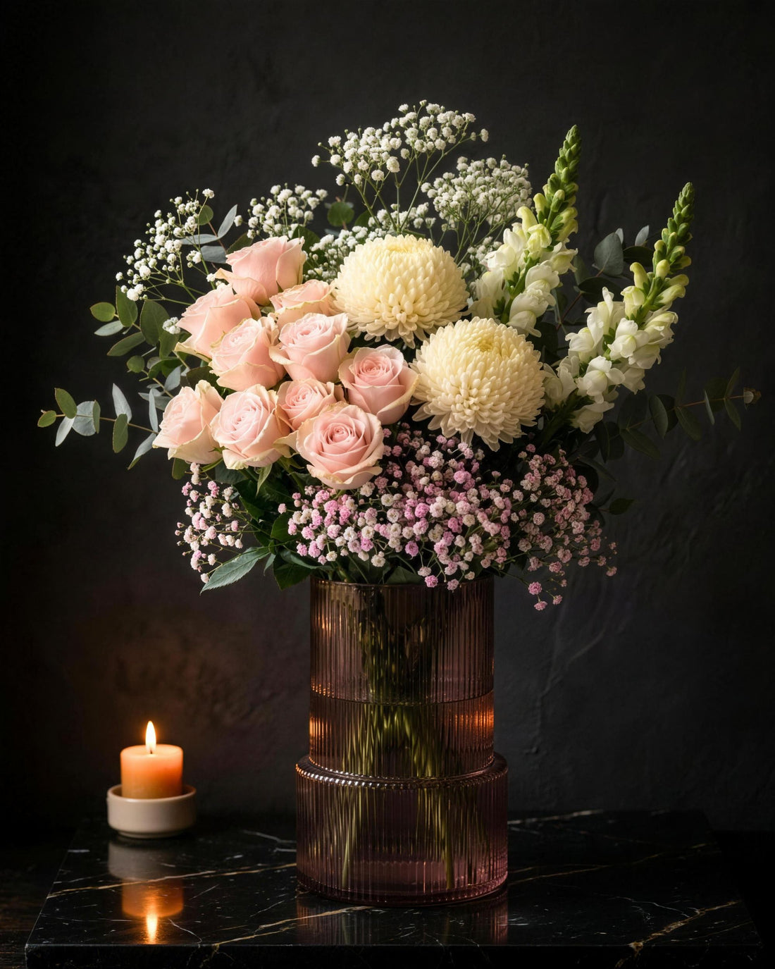 Osaka & Vase by Fig & Bloom in a pink ribbed vase beside a candle