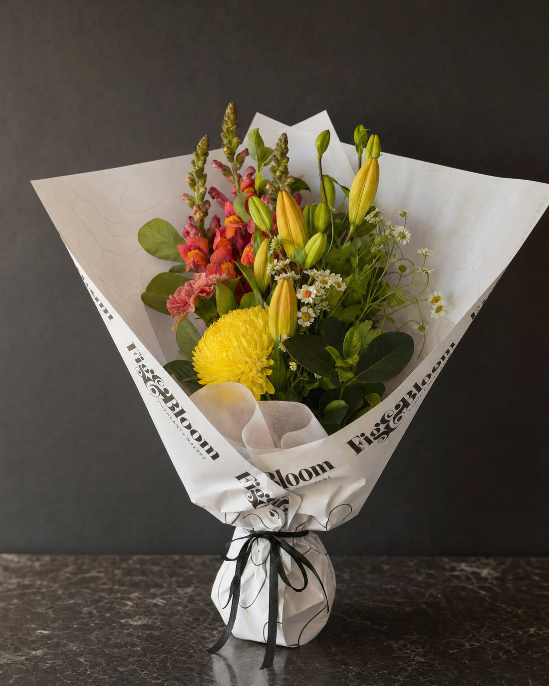 Amalfi Posy by Fig & Bloom: lilies, coral snapdragon and yellow disbud, hand-tied in printed paper