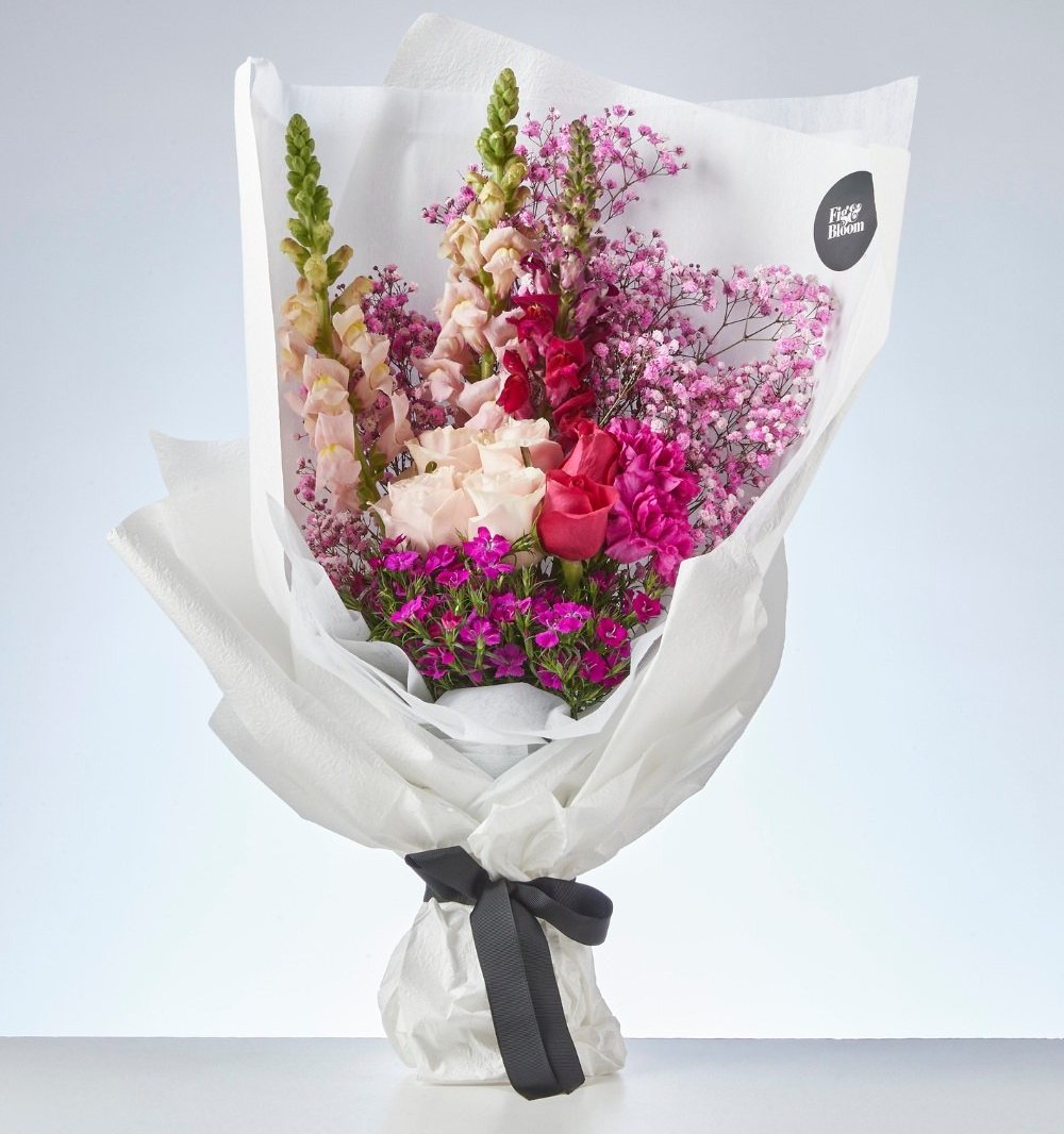 Wrapped Fig & Bloom bouquet with vivid pink, blush and burgundy flowers