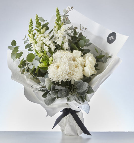 Soft white Fig & Bloom bouquet with greenery for a gentle sympathy gesture