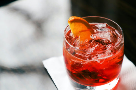 A bitter aperitivo served over ice with a slice of orange