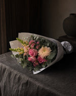 Positano Posy by Fig & Bloom lying on charcoal linen in window light
