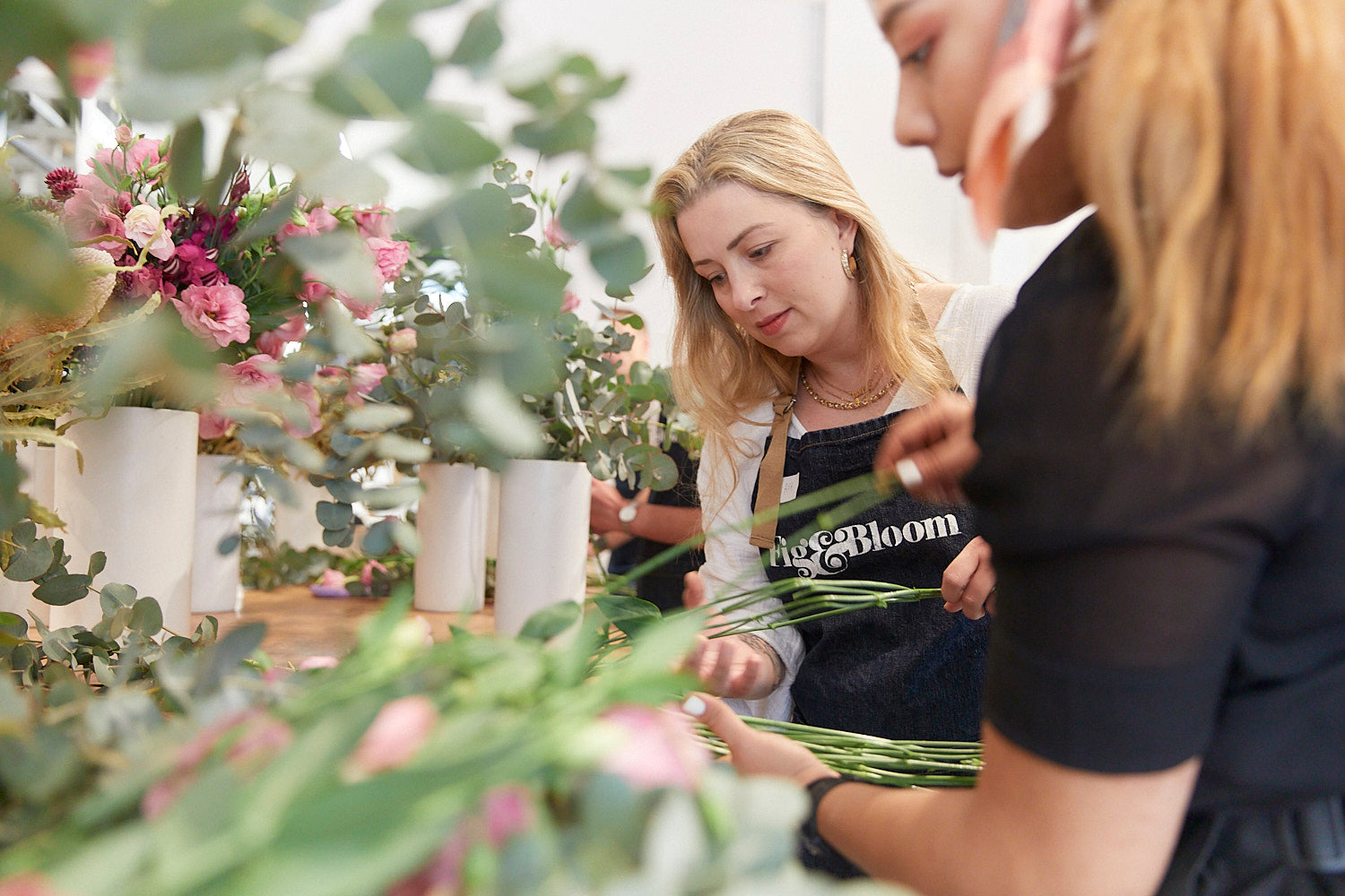 A guest tying off her arrangement