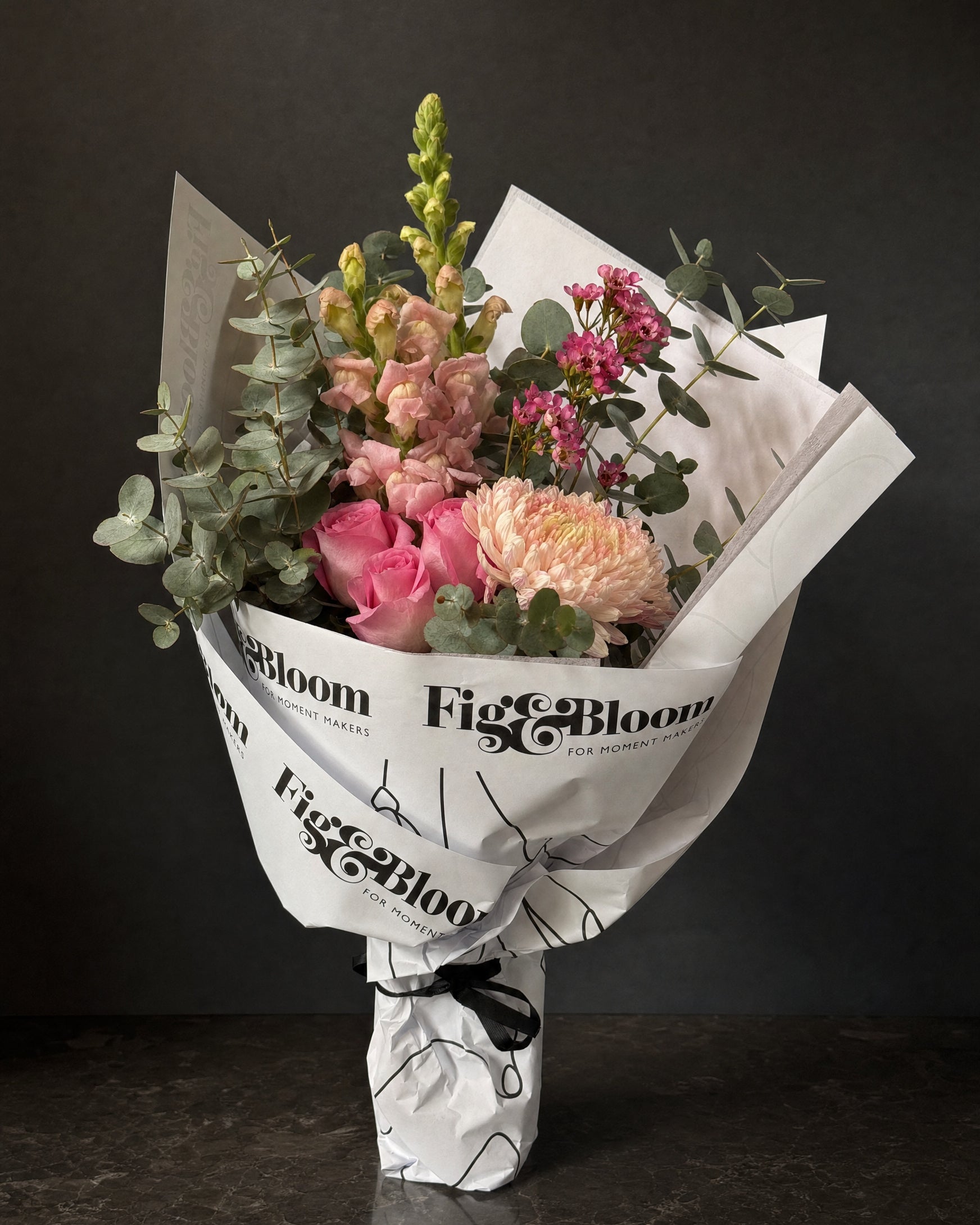 Positano Posy by Fig & Bloom: pink roses, snapdragon and waxflower, hand-tied in printed paper