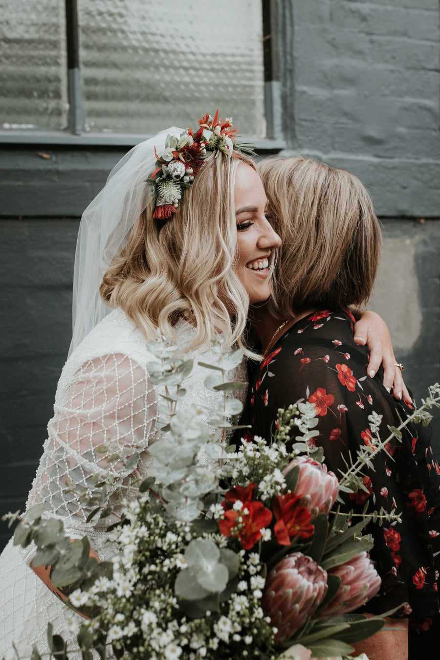 Close view of the bride's red and native floral crown worn with her veil