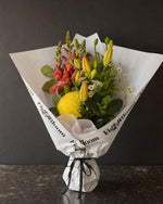 Amalfi Posy by Fig & Bloom: lilies, coral snapdragon and yellow disbud, hand-tied in printed paper