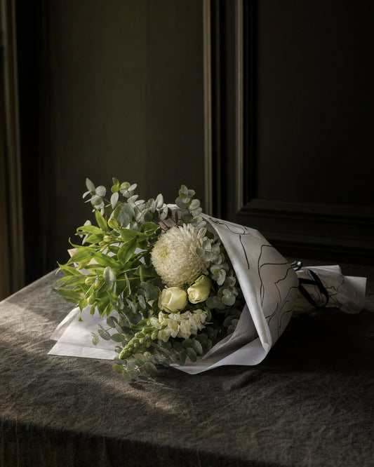 Ravello Posy by Fig & Bloom lying on charcoal linen in window light