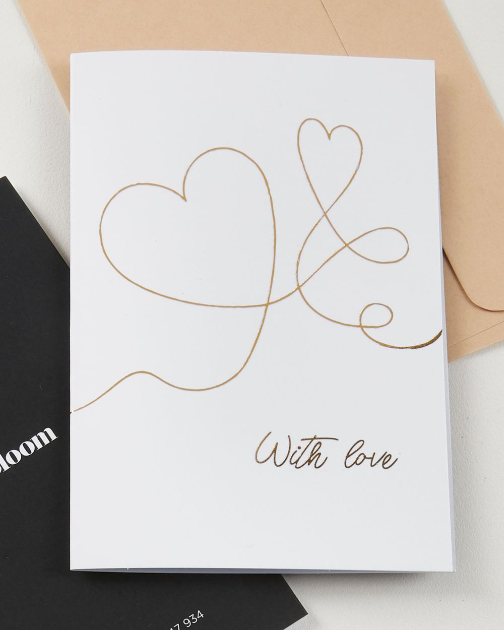 With Love greeting card by Fig & Bloom, gold foil intertwined hearts line illustration with envelope
