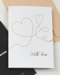 With Love greeting card by Fig & Bloom, gold foil intertwined hearts line illustration with envelope