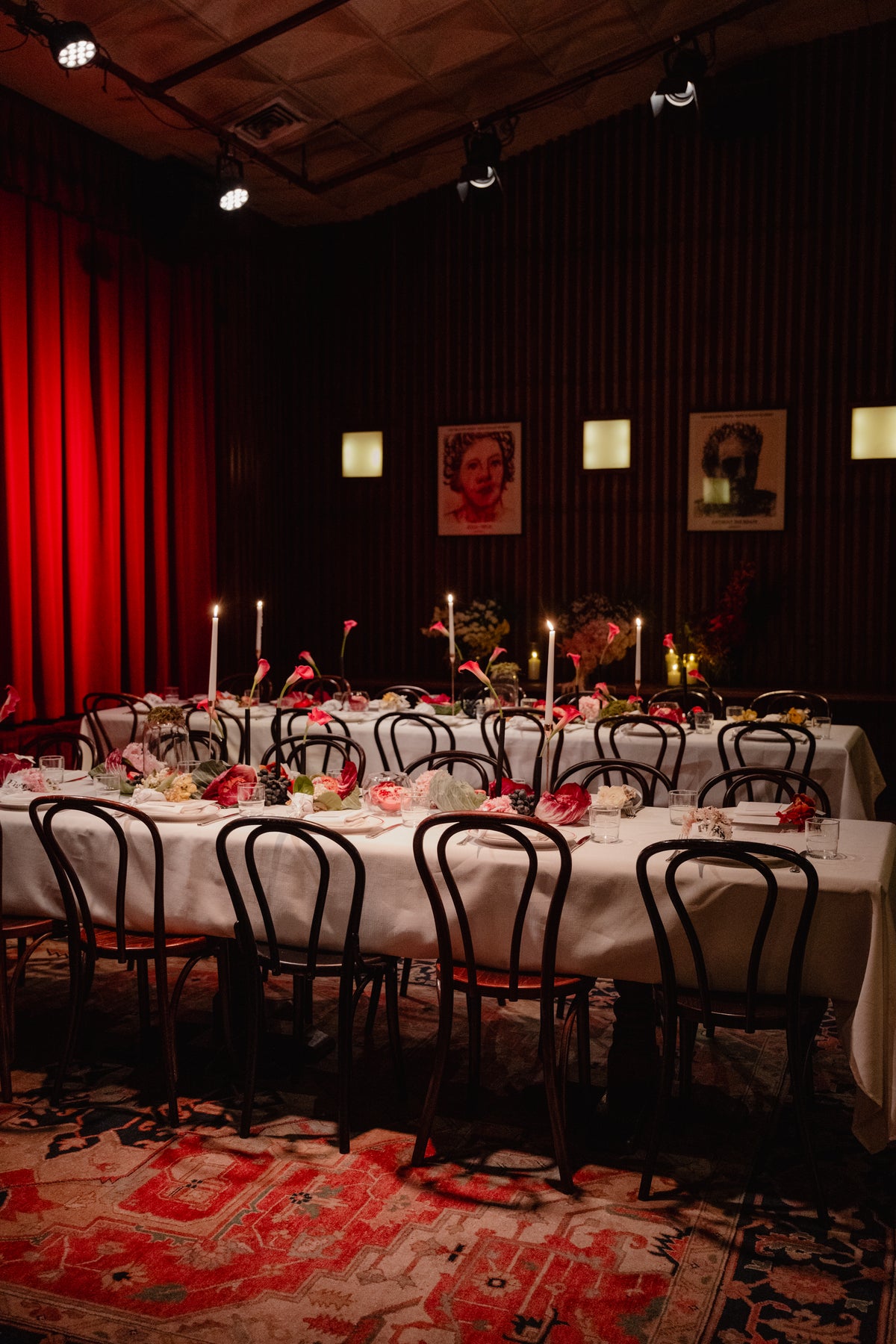 Dining room at Restaurant Hubert set for lunch, with florals and a red curtain