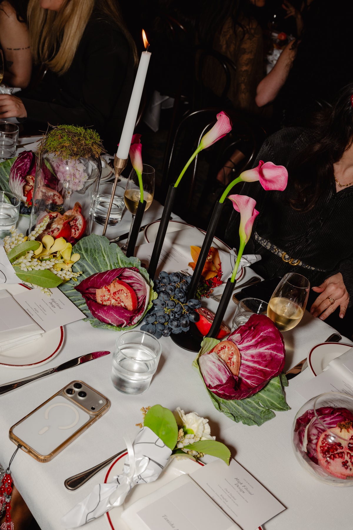 Table detail of calla lilies, radicchio and pomegranate between place settings