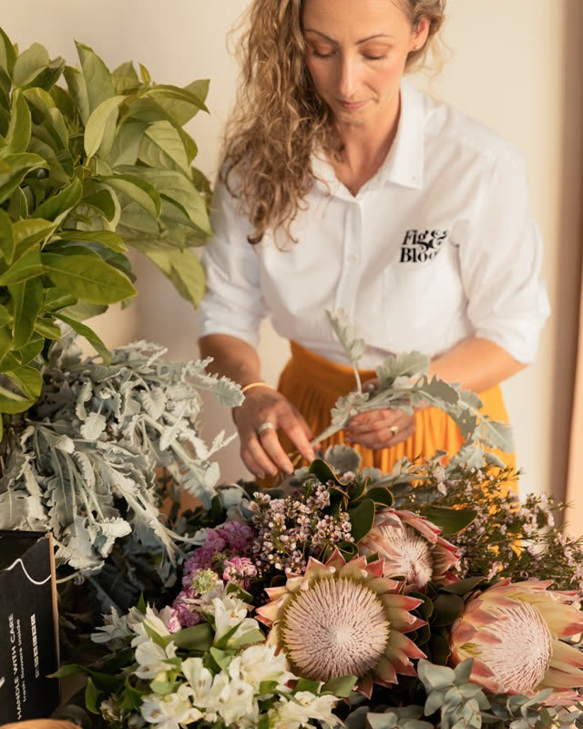 Kellie Brown, founder and creative director of Fig & Bloom, Australia's original premium flower delivery service, arranging king proteas in the studio