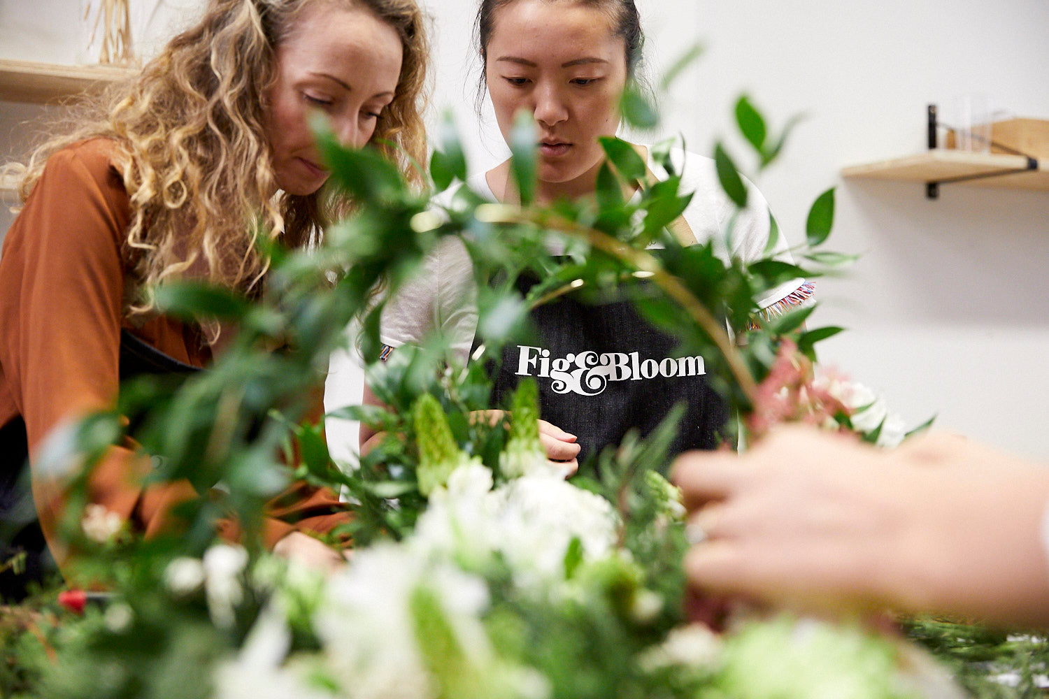 Kellie Brown assembling a foliage wreath at a Fig & Bloom floristry workshop