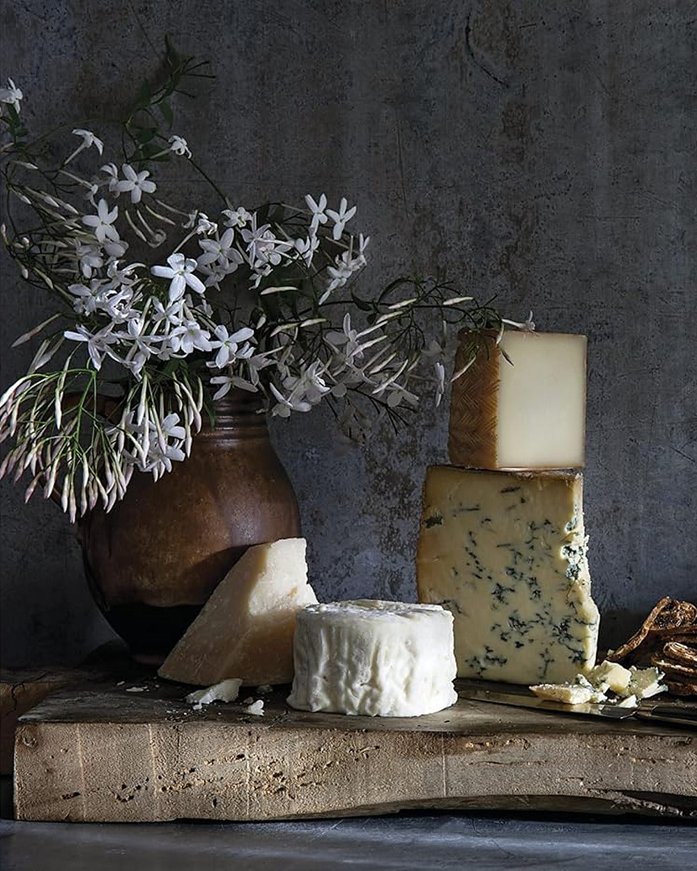 Cheese board with jasmine in a clay vase, from Magnolia Table Volume 3