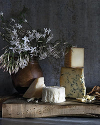 Cheese board with jasmine in a clay vase, from Magnolia Table Volume 3