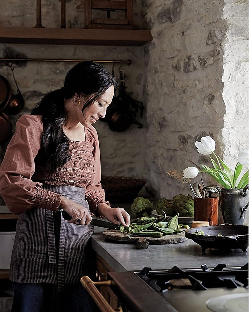 Joanna Gaines cooking in her kitchen, from Magnolia Table Volume 3