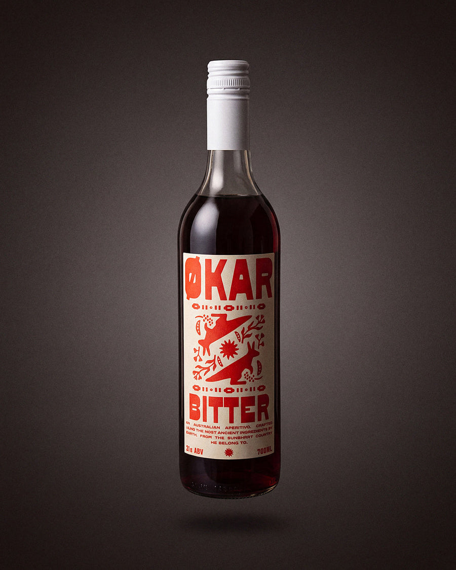 Okar Bitter Aperitivo 700mL by Applewood Distillery, on a warm charcoal studio sweep.