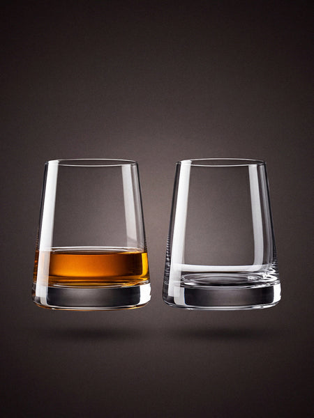 Stolzle Revolution crystal whisky tumblers, a pair, on a warm charcoal studio sweep.