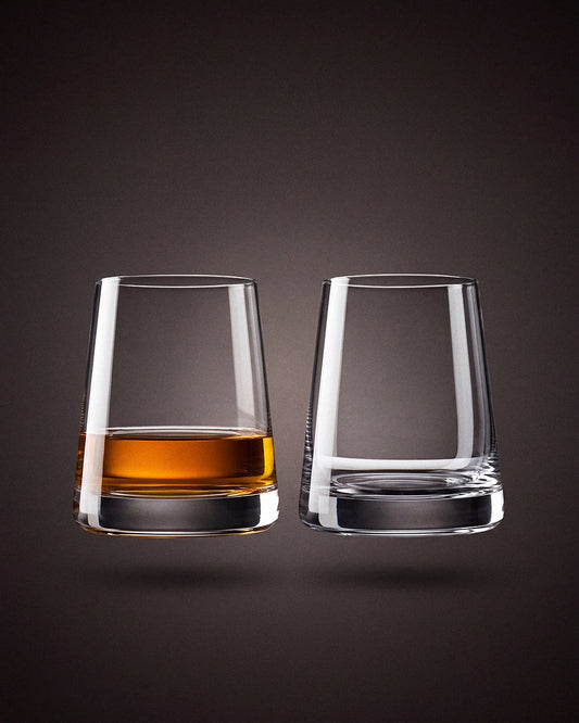 Stolzle Revolution crystal whisky tumblers, a pair, on a warm charcoal studio sweep.
