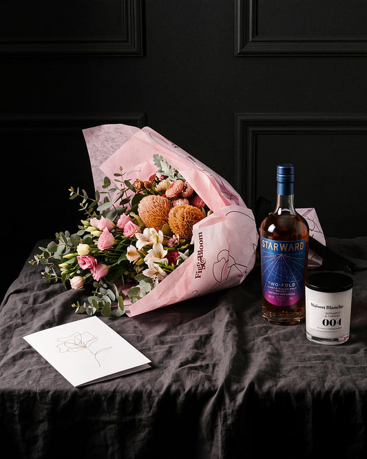 The Nightcap gift set on charcoal linen with Starward Two-Fold, the Maison Blanche candle and the Single Stem greeting card