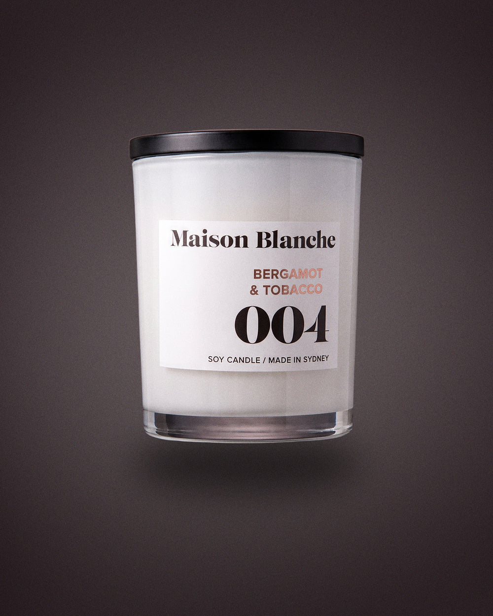 Maison Blanche 004 Bergamot & Tobacco candle, the 15 hour petite candle included in The Nightcap.