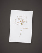 The Single Stem greeting card, gold line art on white, included in The Wish.