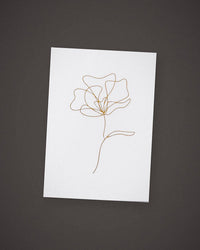 The Single Stem greeting card, gold line art on white, included in The Wish.